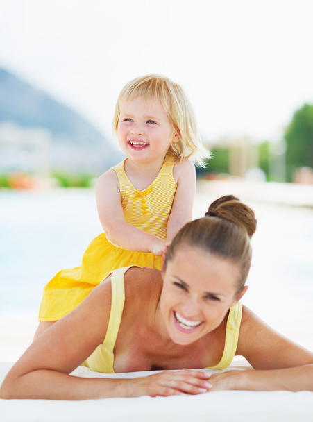 Portrait of happy mother and baby at poolside - Photo, image