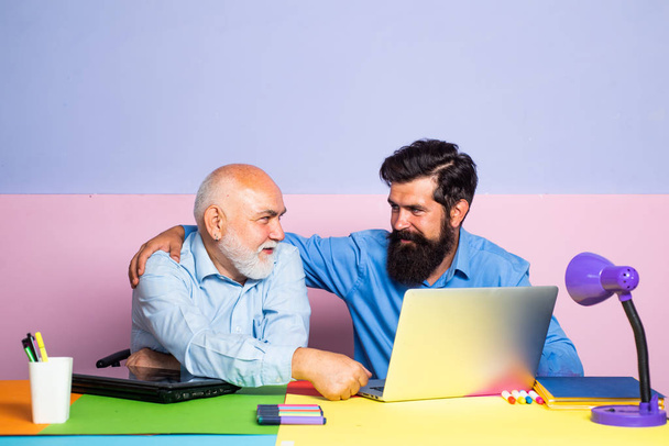 Learning and education concept. Teachers day. Teacher is skilled leader. Friendly bearded man with old mature teacher in classroom. - Photo, image