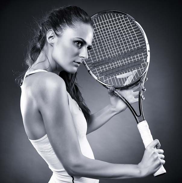 Young female tennis player with racket - Фото, зображення