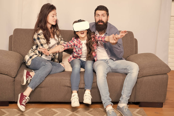Lot of concern surrounding children using VR headsets. Daughter stuck in virtual reality. Digital world. Virtual life and dependence. Parents worry about kid in virtual reality. Virtual cyber gaming - Foto, imagen