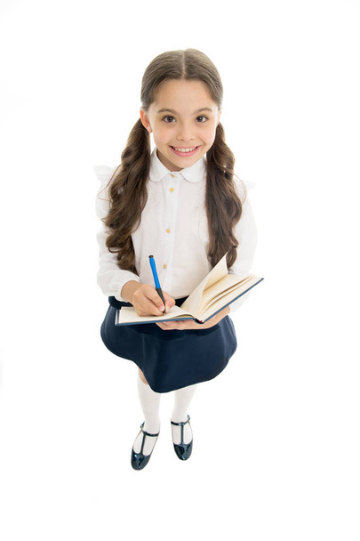 Writing essay. Girl with copy book or workbook. Kid perfect student ready with homework. School girl excellent pupil prepared essay or school project. Schoolgirl wear school uniform. Knowledge day - Фото, изображение