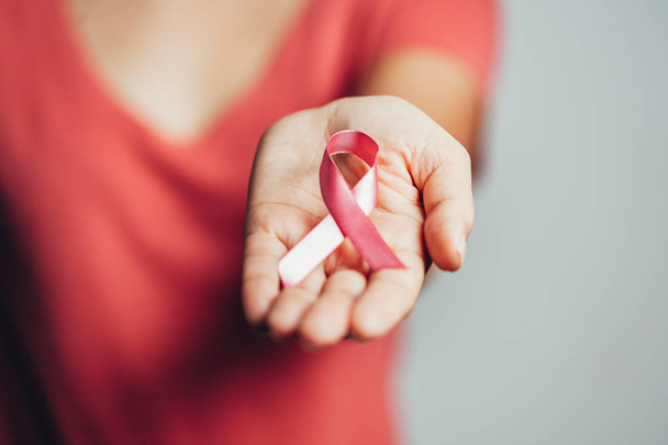Healthcare and medicine concept - woman holding pink breast cancer awareness ribbon - Photo, Image