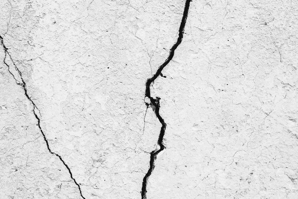Texture of a concrete wall with cracks and scratches which can be used as a background - Photo, Image