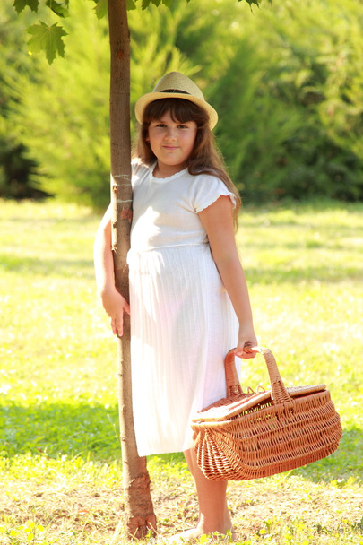 Young girl holding a basket - 写真・画像