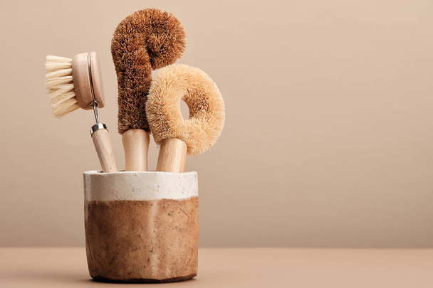 Kitchen Dish Brushes in Brown Ceramic Cup - Photo, image