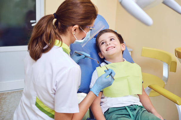 A child with a dentist in a dental office. - Fotó, kép