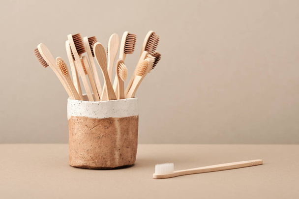 Wooden Eco Toothbrush in Brown Ceramic Cup - Fotó, kép