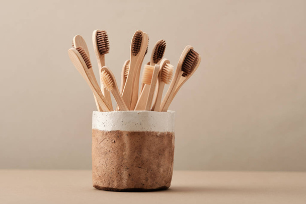 Wooden Eco Toothbrush in Brown Ceramic Cup - Fotoğraf, Görsel