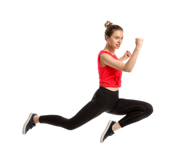 Jumping sporty woman on white background - Foto, afbeelding