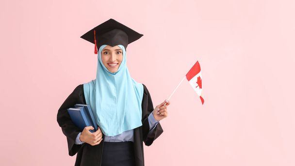 Muslim female graduate with Canadian flag on color background - Photo, Image