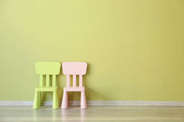 Chairs near color wall in room - Photo, Image