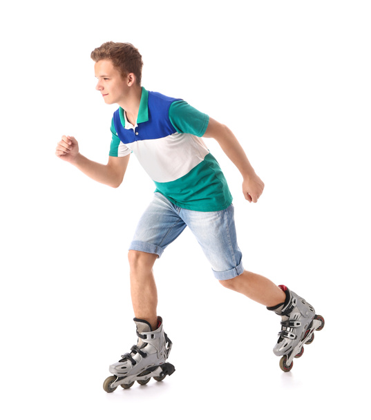 Teenage boy on roller skates against white background - Foto, imagen