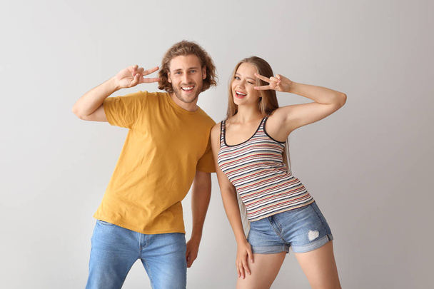 Cool young couple dancing against white background - Foto, Imagem