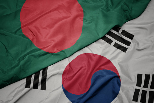 ondeando colorida bandera de Corea del Sur y bandera nacional de bangladesh
. - Foto, Imagen
