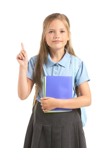 Little schoolgirl with raised index finger on white background - Valokuva, kuva