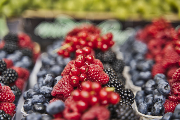 Focus selettivo Varie bacche fresche estive nel mercato biologico. Concetto di cibo sano. - Foto, immagini