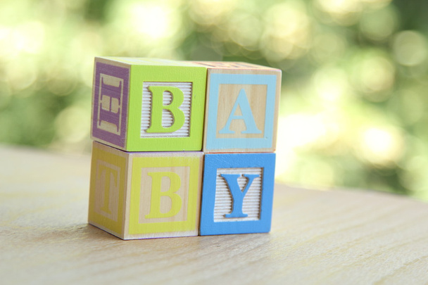 Word baby lined with children's wooden blocks for elementary education alphabet - Fotografie, Obrázek