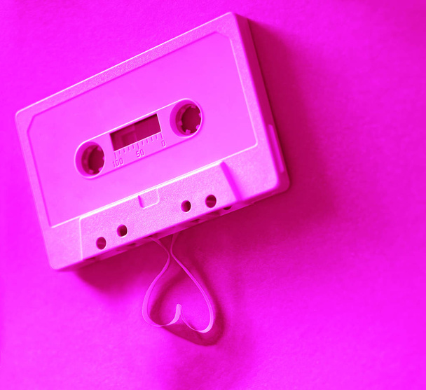 tape  coming out of the cassette to form heart shape. Vintage audio cassette  - Fotoğraf, Görsel
