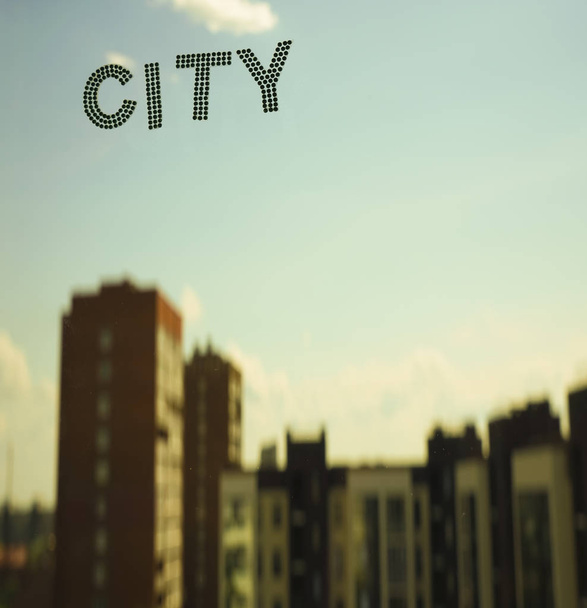 word - city on blue sky and highrise buildings background.  - Foto, imagen
