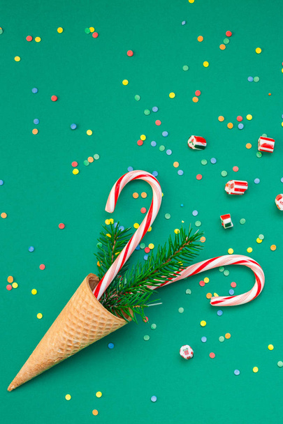 Christmas card with candy canes in waffle cone - 写真・画像
