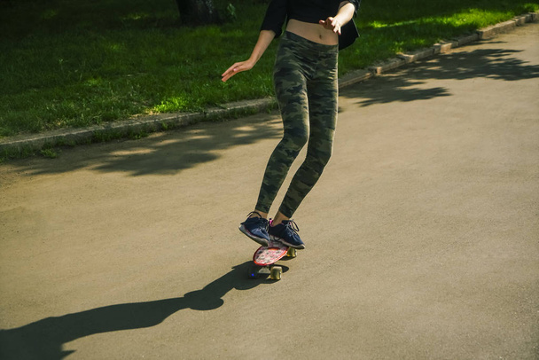no face. young girl with a skateboard. Female skateboarder skateboarding at skatepark - Photo, Image