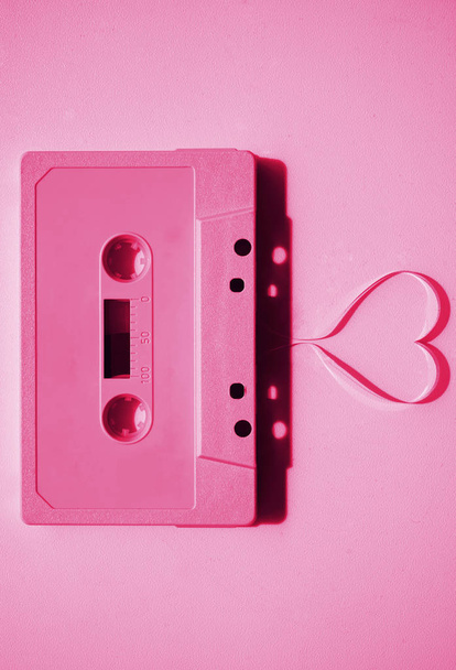 tape  coming out of the cassette to form heart shape. Vintage audio cassette  - Φωτογραφία, εικόνα