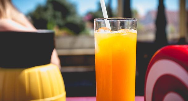 orange juice seated on the table of a terrace - Photo, Image