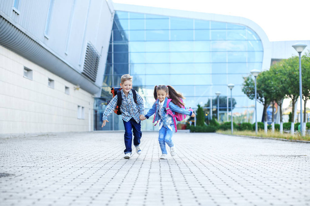 Children run with backpacks. The concept is back to school, study, friendship. - Fotoğraf, Görsel