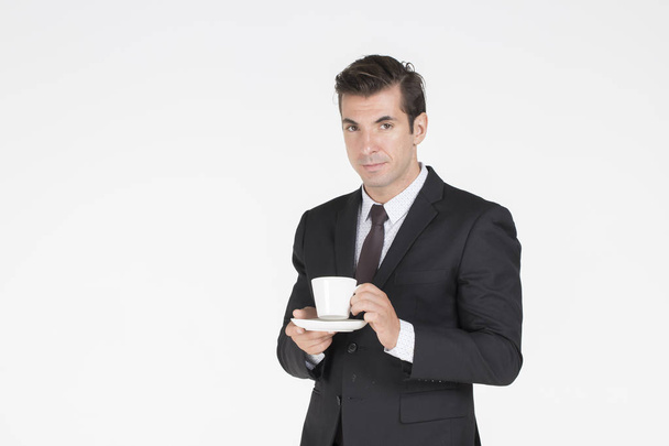 Handsome business man standing drinking coffee and so smart - Zdjęcie, obraz