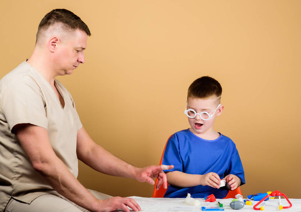 medicine and health. happy child with father with stethoscope. family doctor. trust and values. father and son in medical uniform. small boy with dad in hospital. medicine concept. medicine game - Fotoğraf, Görsel