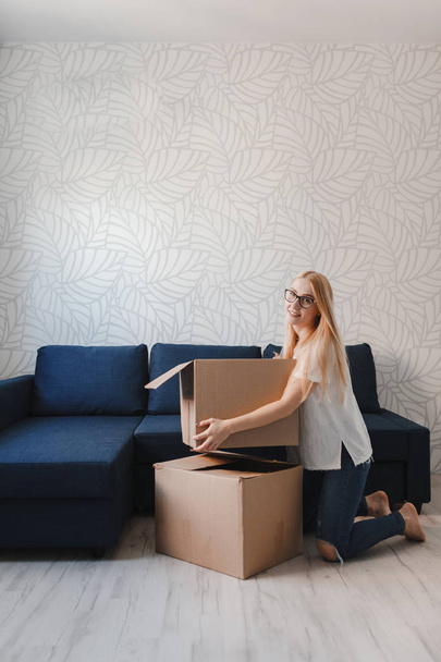 Photo of young blonde with cardboard box - Fotoğraf, Görsel