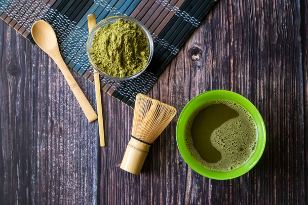 matcha of green tea in a bowl on a wooden surface. Top view, contains antioxidants, detox. Horizontal orientation - Fotografie, Obrázek