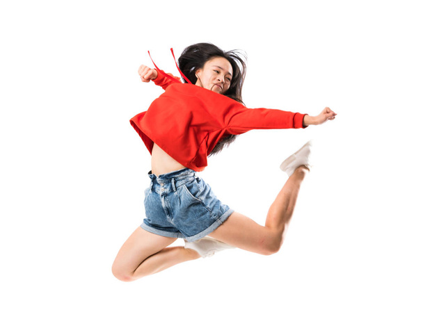 Young asian dancer over isolated white background - 写真・画像