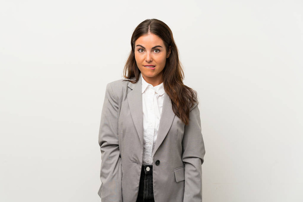 Young business woman over isolated white background having doubts and with confuse face expression - Foto, Imagem