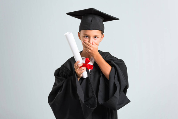 Little boy graduating laughing on grey background - Photo, Image