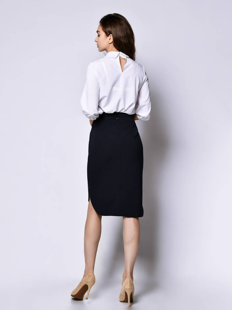 beautiful woman office manager posing in a new casual white blouse and classic straight dark skirt - Zdjęcie, obraz