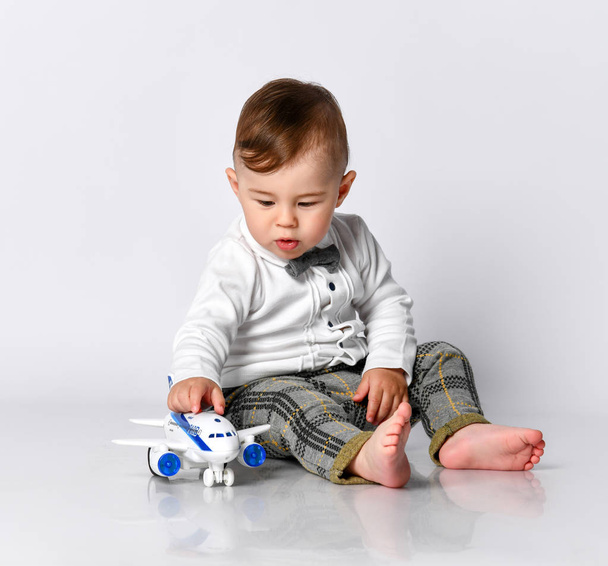 happy child toddler playing with toy airplane and dreaming of becoming a pilot - Foto, imagen