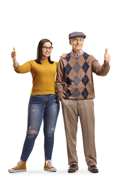 Grootvader en kleindochter staan en tonen duim omhoog - Foto, afbeelding