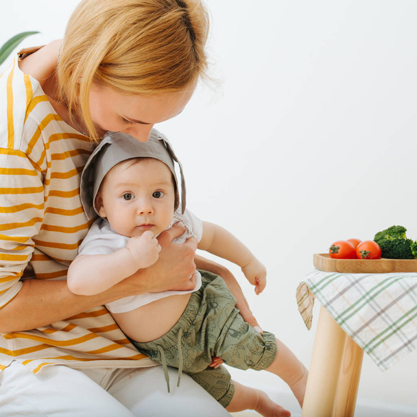 Active restless infant child is presented food - Φωτογραφία, εικόνα
