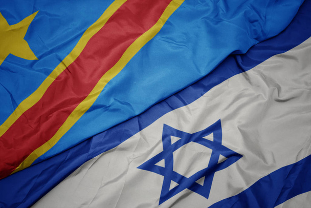 waving colorful flag of israel and national flag of democratic republic of the congo. - Photo, Image