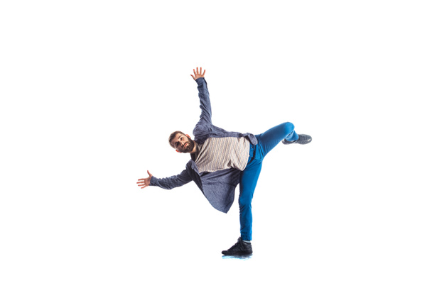 Young guy is training gymnastics in isolated room and white background - Foto, imagen