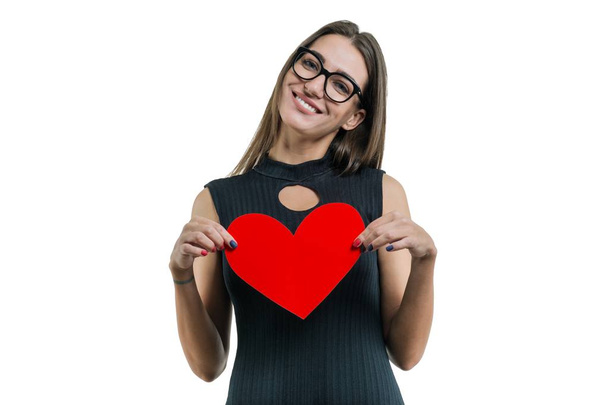 Isolated portrait of young woman with paper red heart - Foto, Bild