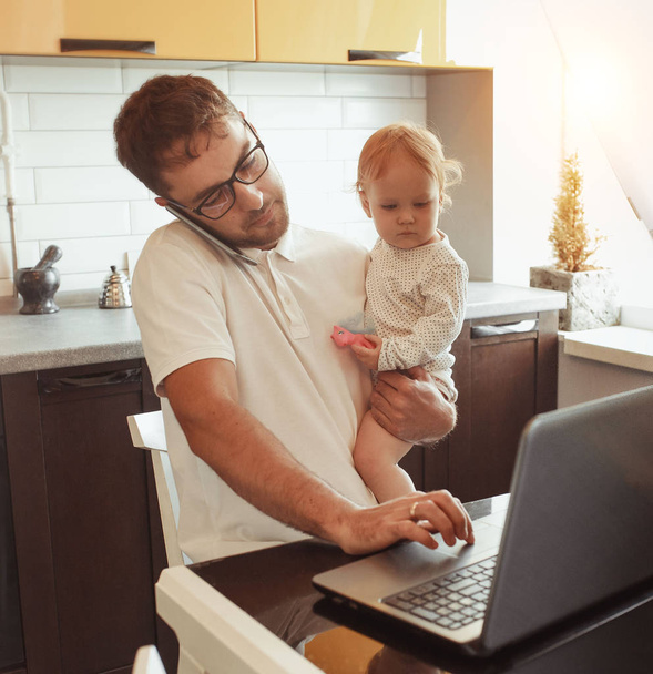 Father Working From Home On Laptop With Baby daughter - Fotó, kép