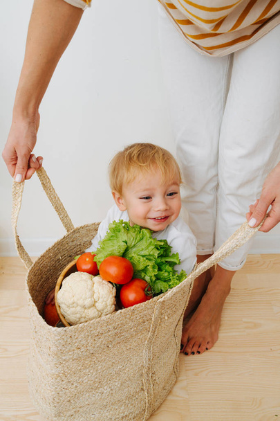 Happy little toddler boy with ton of vegetables - Valokuva, kuva