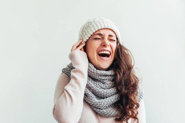 Laughing girl wearing warm clothes hat and scarf isolated on white background - Fotoğraf, Görsel