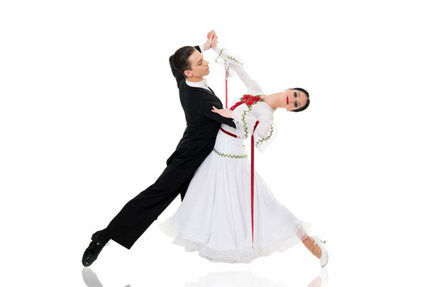 ballroom dance couple in a dance pose isolated on white background. ballroom sensual proffessional dancers dancing walz, tango, slowfox and quickstep just dance - Fotografie, Obrázek