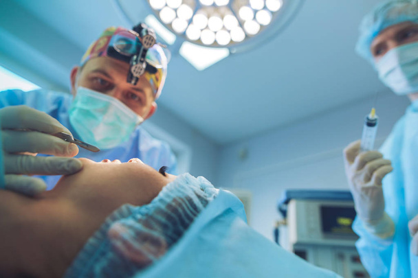 Man surgeon at work in operating room - Photo, image