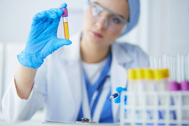 Laboratory assistant woman analyzing a blood sample - Fotografie, Obrázek