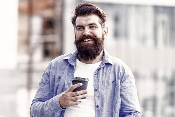 Make yourself useful. Man drink take away coffee. Bearded man relax outdoors. Coffee break concept. Caffeine addicted. Morning coffee. Mature hipster enjoy hot beverage. Coffee completes me - 写真・画像