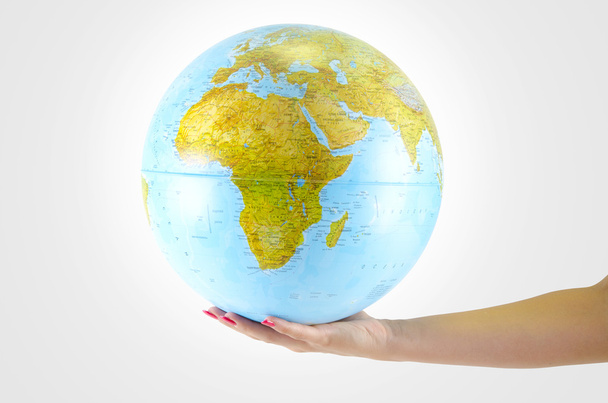 Earth globus in hand, various background - Фото, зображення